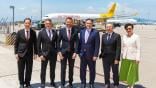 executives standing in front of an Air Hong Kong aircraft