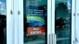 Glass doors with Golden Dome summit sign